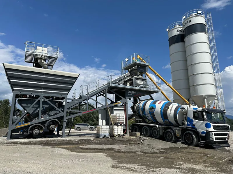 GRAU G100M mobile concrete plant on site, with its two cement silos and a truck mixer