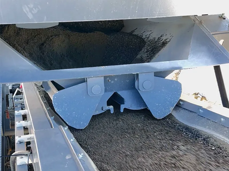 GRAU mobile concrete plant’s independent aggregate weigh hopper, its gates releasing aggregate onto the belt below